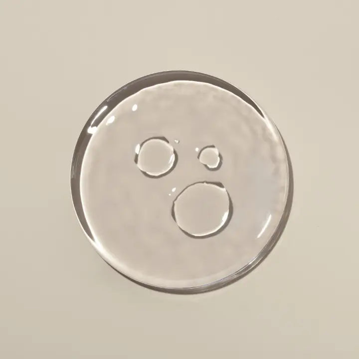 Close-up of Act + Acre Cold Processed Scalp Detox liquid formula, showing lightweight, fast-absorbing texture.