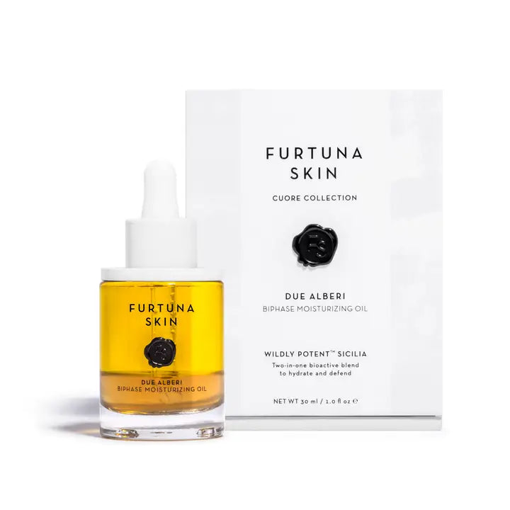 Furtuna Skin Due Alberi Biphase Moisturizing Oil in a glass dropper bottle with golden-yellow oil, displayed next to its luxury white packaging from the Cuore Collection.
